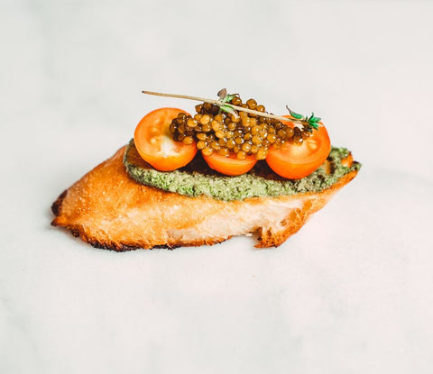 Fish with pesto, tomatoes of fresh caviar on top