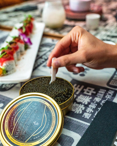 using a spoon to pull Imperia Caviar from the tin